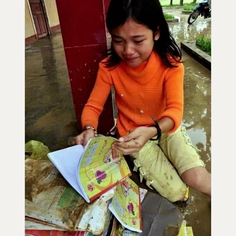 A girl with a flood-damaged book