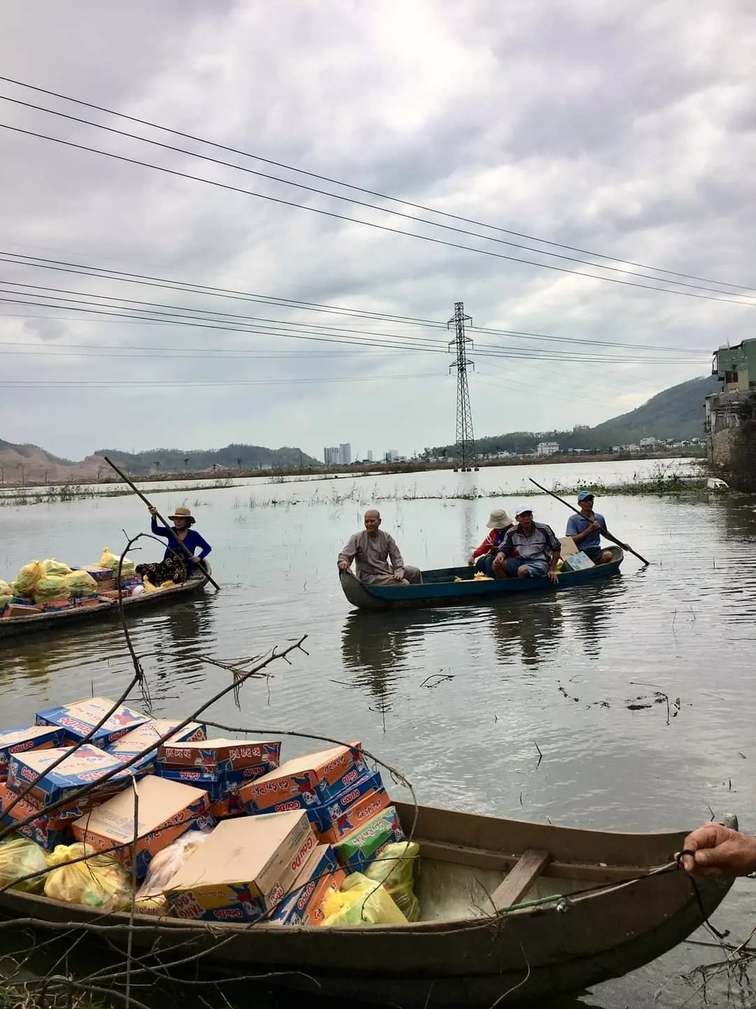 Small boats loaded with boxes of food on a river in Vietnam