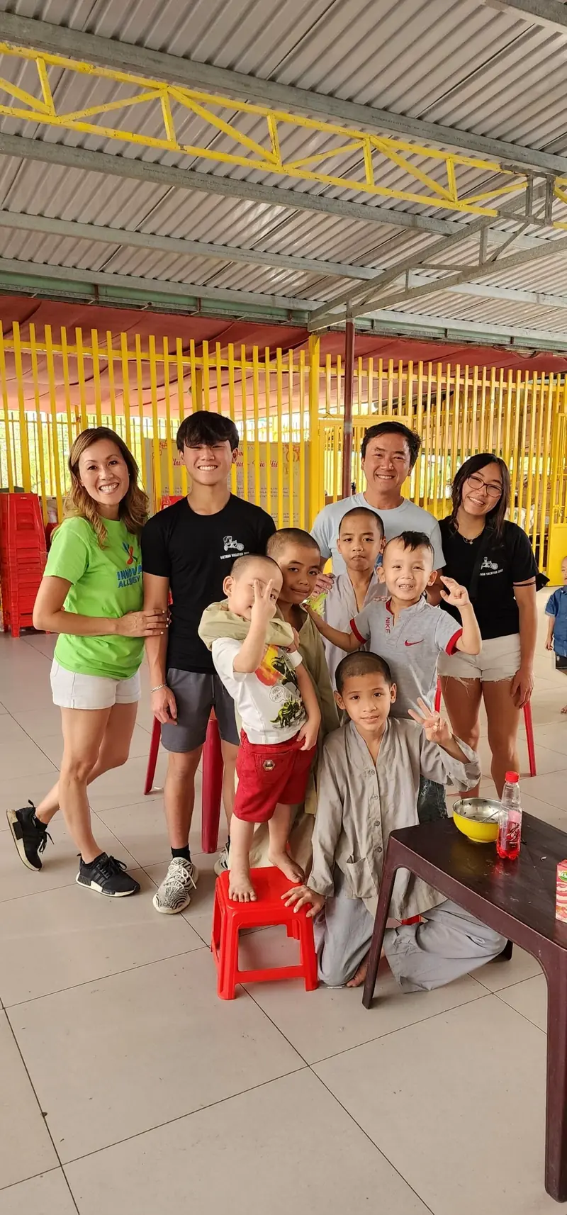 Children make peace signs in a group photo