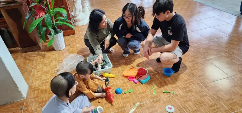 Rilina and Dylan with children and their toys