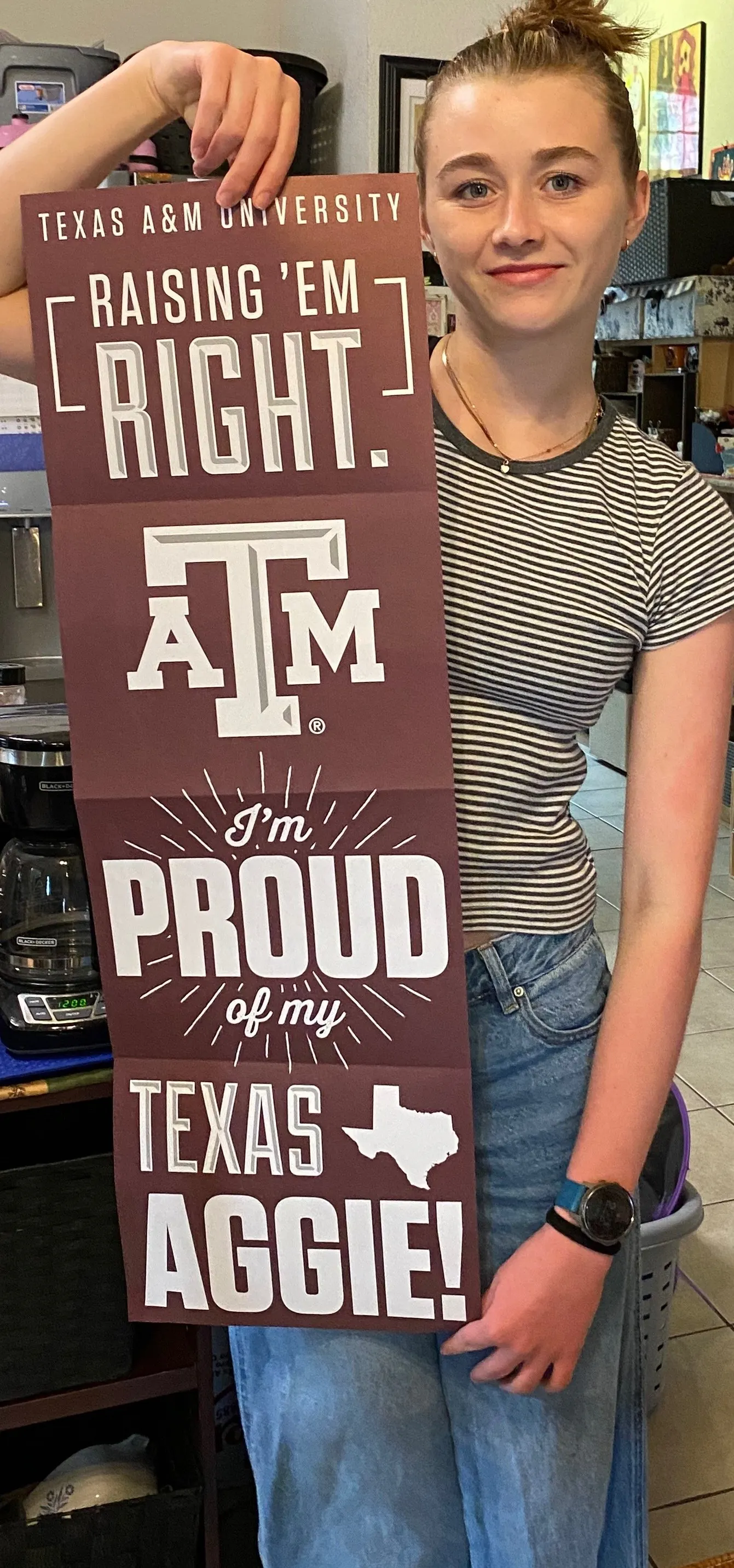 Samantha Paige Svetlik holds a Texas A&M sign